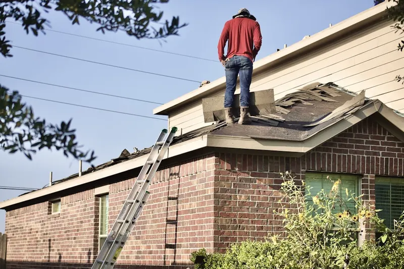 Professional roofer working on a residential roof in Shorewood
